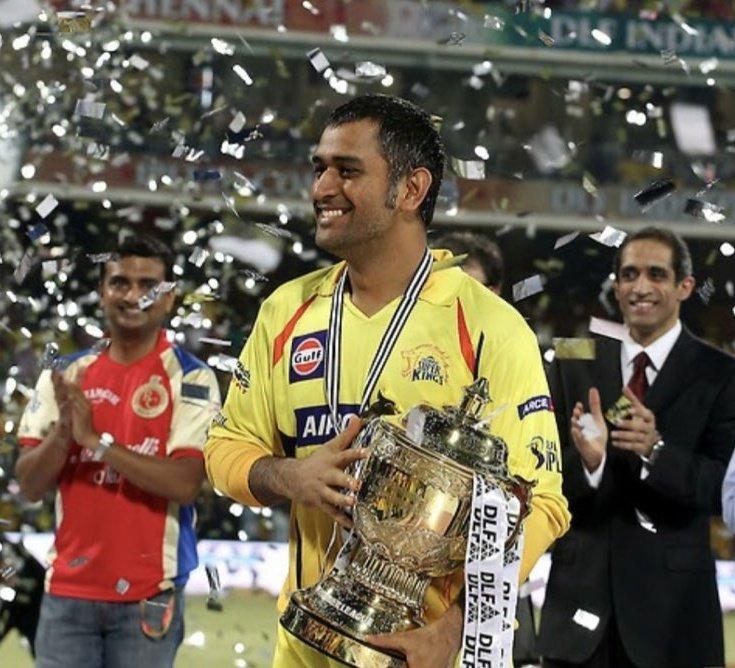 MS Dhoni holding 2011 IPL Trophy under confetti with CSK